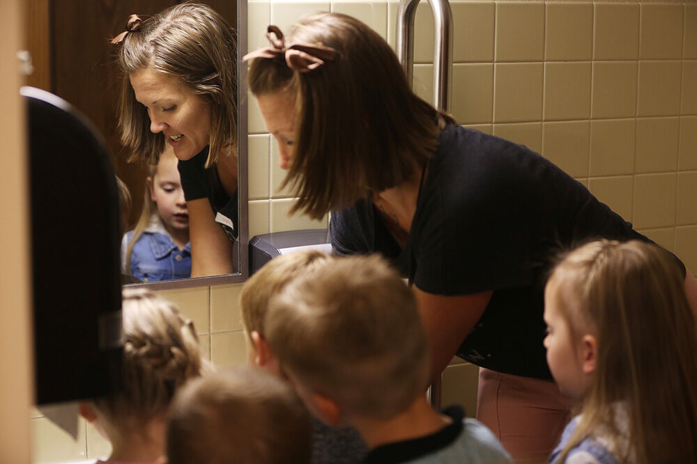 Alicia LaVigne works with the kids to learn how to use the bathroom